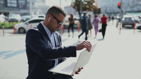 businessman is working near office center on a busy crowded street in downtown cityの写真素材