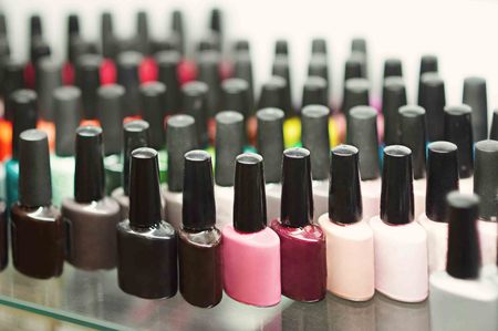 Set of different nail varnishes on shelves in cosmetic beauty saloonの写真素材
