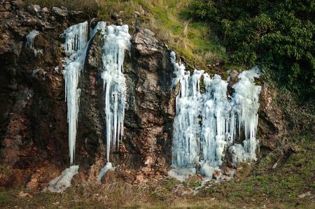 Frozen waterfall in winter time in the mountainsの写真素材