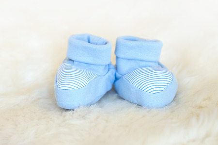 Waiting baby, baby shower. Blue newborn shoesの写真素材