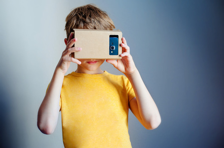 Young boy with hand holding virtual reality deviceの写真素材
