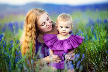 Lifestyle portrait mom and daughter in happines at the outside in the meadowの写真素材