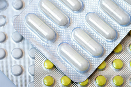 Colorful capsules and pills packed in blisters