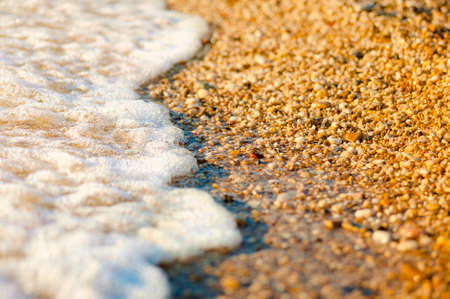 sea wave over the pebbles on the beach, abstract natural backgroundの写真素材