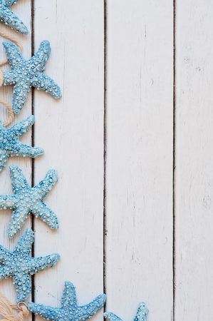 Sea travel frame decor with seashells and rope over wooden backgroundの写真素材