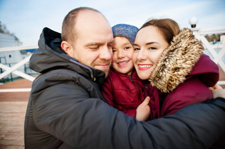 Portrait of happy young couple with son in parkの写真素材