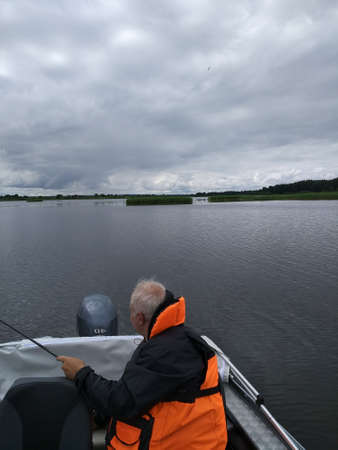 A man in a boat is fishing. Camping. Fishing.のeditorial素材