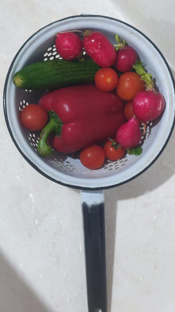 fresh radish and red peppers in a plate in the kitchen, eating vegetables. high quality photo