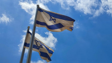 two Israeli flags against the blue sky, white-blue symbol of the country. high quality photo