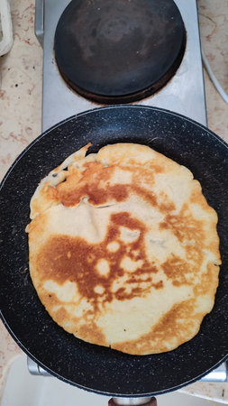 pancake on black frying pan homemade food, baking cooking. high quality photo
