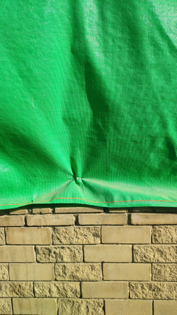 stone wall fence, green awning fencing. High quality photoの写真素材