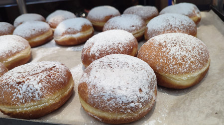 round donuts made from dough with powdered sugar, Israeli pastries, Hanukkah holiday. High quality...