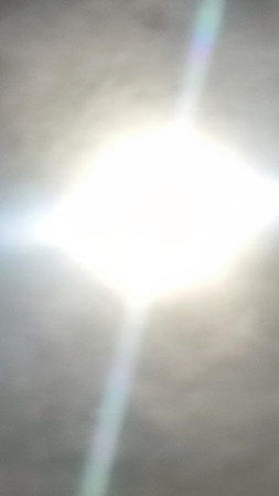 white round sun, ray of light, blue gray sky, nature weather background. High quality photo