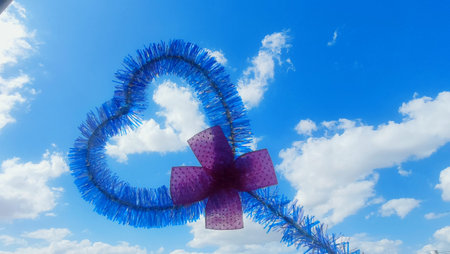 blue sky, white clouds, heart symbol, love background. High quality photo