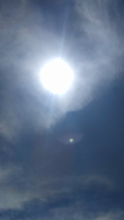 sun sky clouds rays of light background halo circle nature. High quality photo