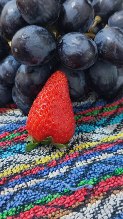 black grapes and strawberries, healthy foods, fruits. High quality photoの写真素材