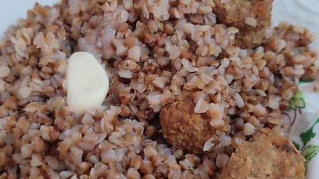 boiled buckwheat porridge in a plate, cooking healthy food diet lunch. High quality photoの写真素材