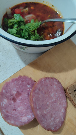 sandwich bread with salami sausage and white cheese, red soup food cooking snack. High quality photoの写真素材