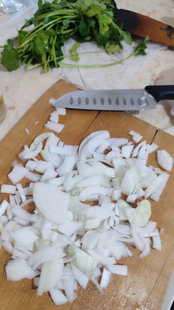 onion chopped on wooden kitchen board, healthy food vegetables, knife, greens. High quality photoの写真素材