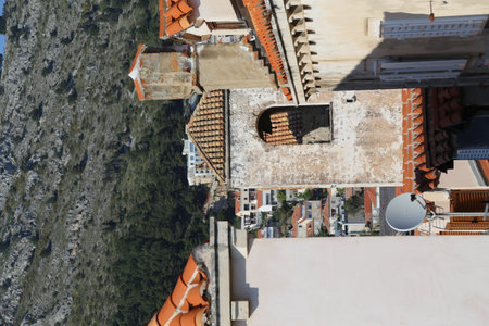 Dubrovnik, Croatia, old town, tiled roof of a house ancient stone building with a triangular facade, top view, travel places, windows April 22, 2023. High quality photoの写真素材
