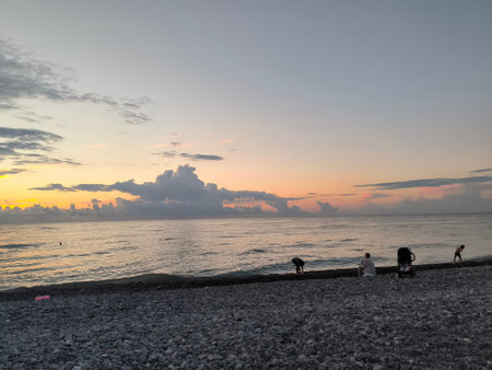 Sea water sunset sky landscape summer beach background blue nature orange light wallpaper evening people white clouds . High quality photoの写真素材