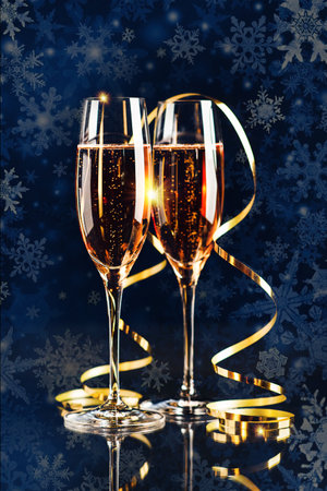 Happy New Year! A golden bucket with champagne, two glasses and a golden serpentine against the background of a clock face.の写真素材