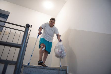 A disabled person takes out garbage