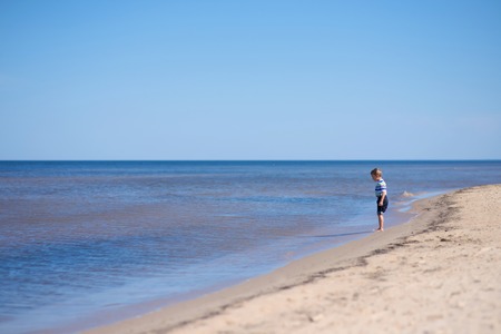 Horizon. Kid on the beachの写真素材