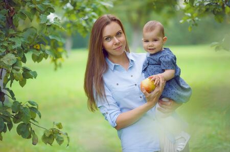 Beautiful mother and her child in the parkの写真素材