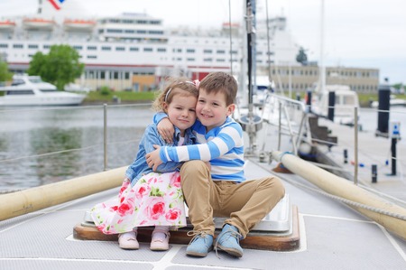 Family. Sister and brother on the boatの写真素材