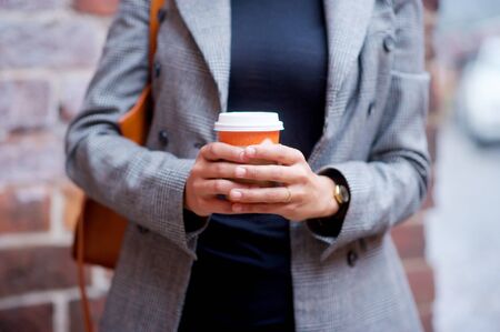 Business, fashion. Woman coffee cup on the streetの写真素材