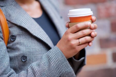 Business, fashion. Woman coffee cup on the streetの写真素材