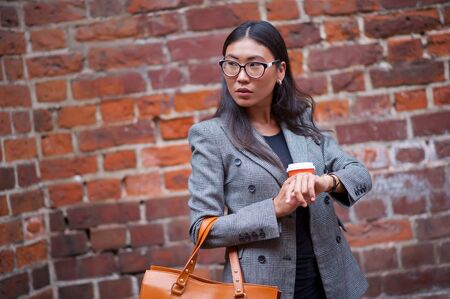Business, fashion. Woman coffee cup on the streetの写真素材