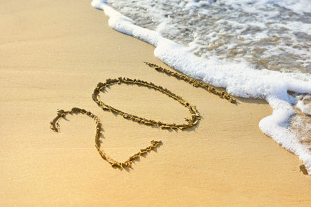 New year 2015 written on sand