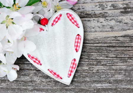 Spring Blossom and heart over wooden background