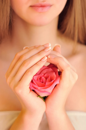 Closeup image of pink french manicure with roseの写真素材