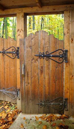 Ornate wooden gate with wrought iron hingesの写真素材