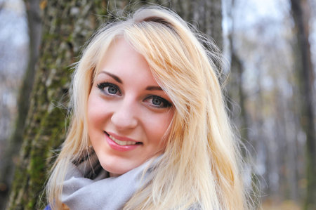 Portrait beautiful woman in autumn parkの写真素材