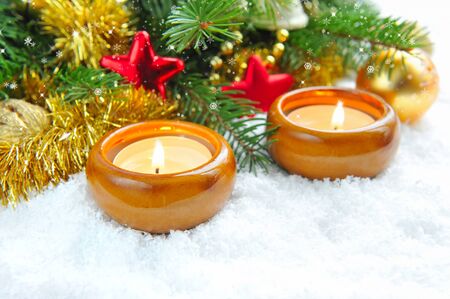 Christmas composition is with candles on snowの写真素材
