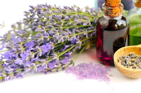 Lavender fresh flowers and lavender oil on white backgroundの写真素材