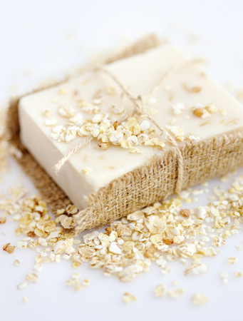 Handmade soap with oatmeal and milk on a white backgroundの写真素材