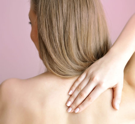 Woman with hand on shoulder. Focus is on a hand