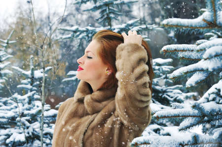 Young woman in winter forestの写真素材