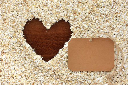 Frame of oat flakes in the form of heart and blank paper stickerの写真素材
