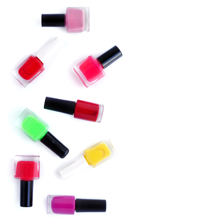 Coloured nail polish bottles on white background with copy space. Top viewの写真素材