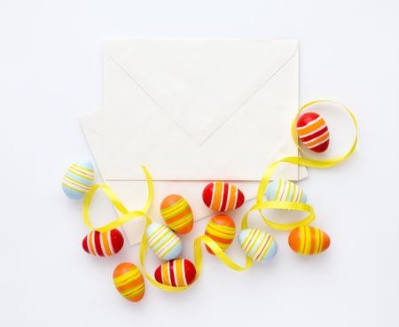 Festive background with easter eggs with ribbons and envelopes. Top viewの写真素材