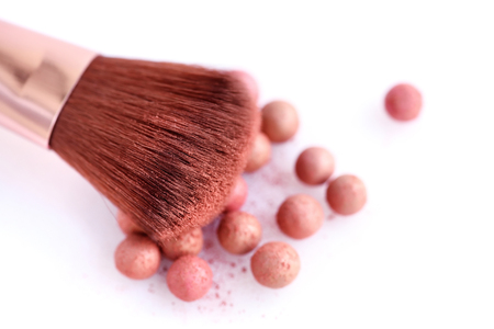 Cosmetic powder balls and makeup brush, isolated on white background. Shallow depth of focusの写真素材