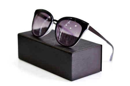 Fashionable sunglasses with box on white backgroundの写真素材