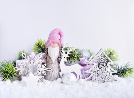 Christmas composition with the gnome, deer, spruce branches and festive decorations Ð¾n the snow.の写真素材