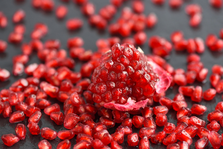 Close-up pomegranate and seeds scatteredの写真素材